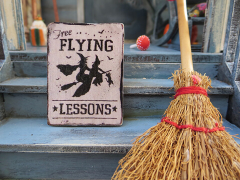 A broomstick and sign
